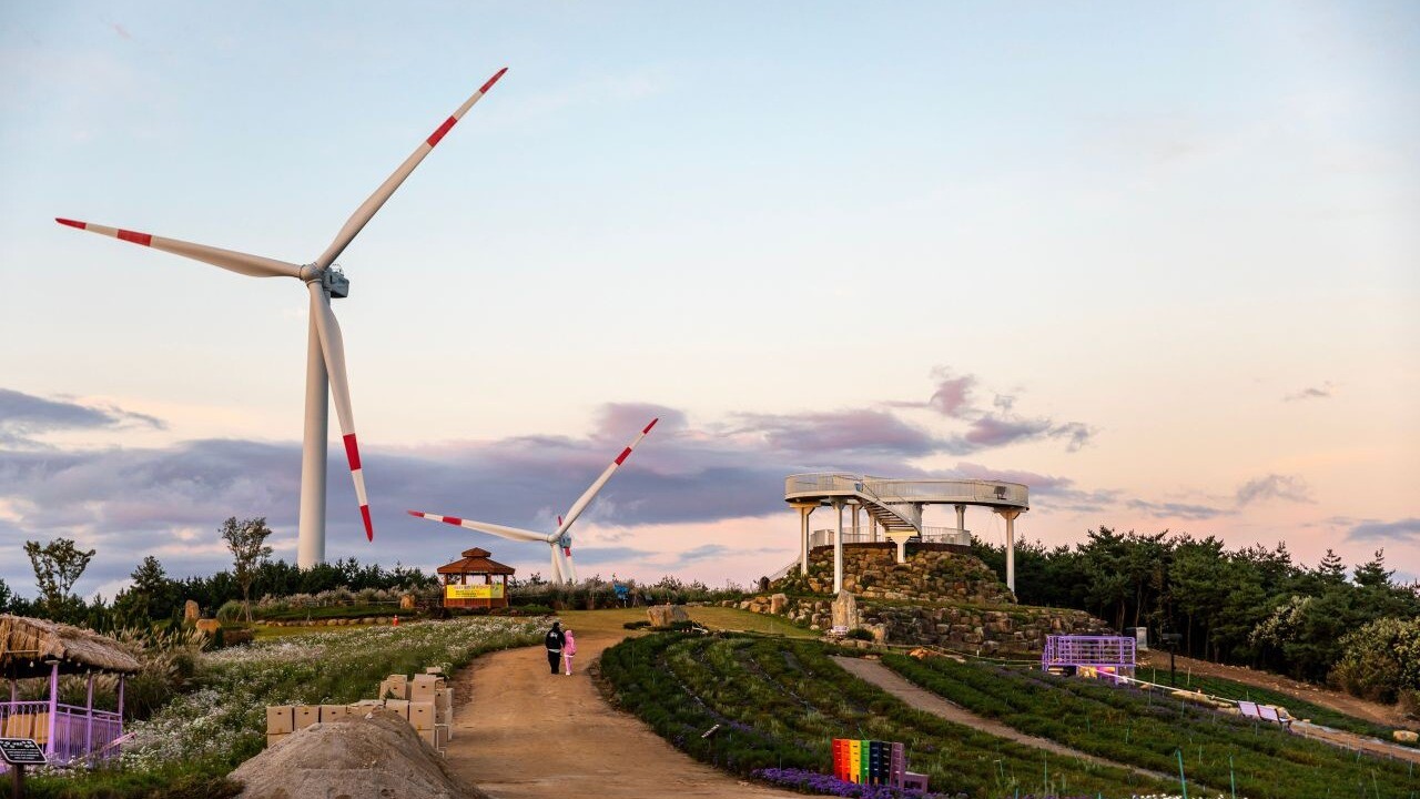 Walking path, rest shelter and wind turbines on Byeolbaram Hill