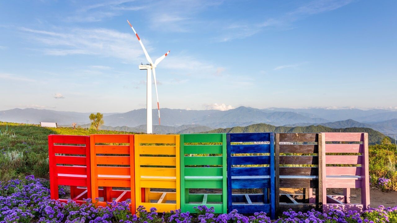 Purple asters, colorful chairs and a wind turbine on Gamaksan's Byeolbaram Hill