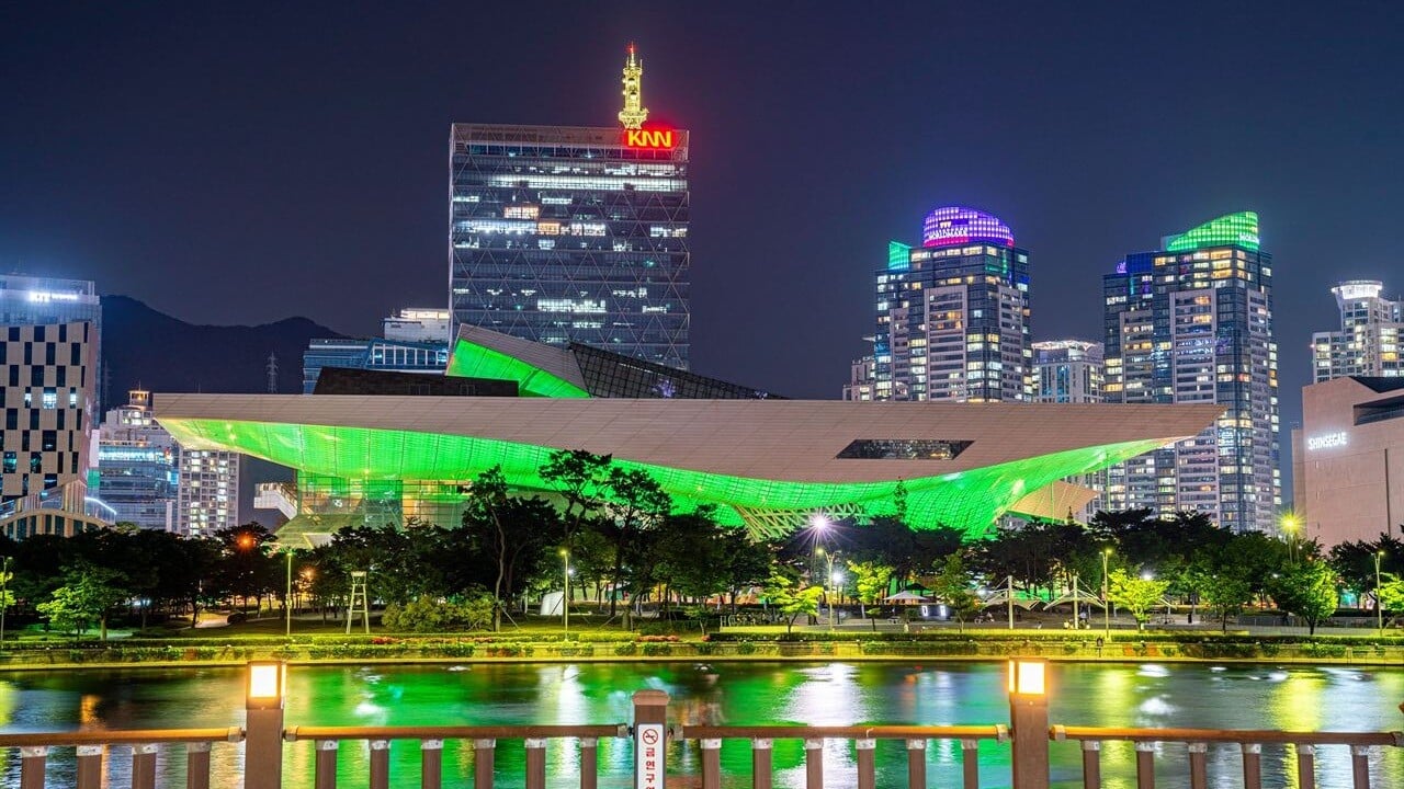 Busan Cinema Center reflected in the Suyeong River at night