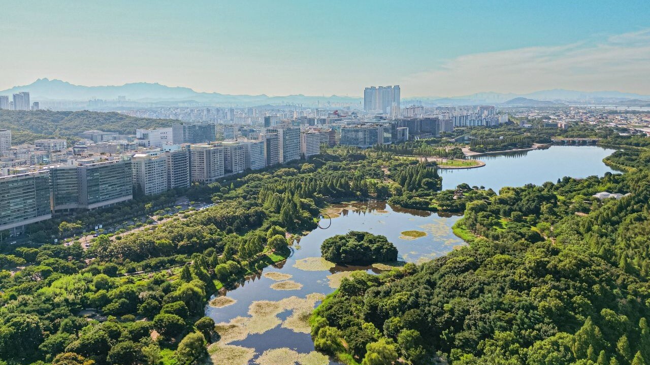 Aerial view of Ilsan Lake Park surrounded by urban buildings
